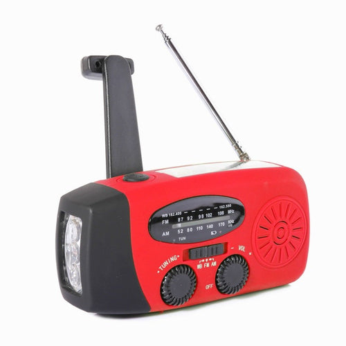 Red solar crank emergency radio with aerial, torch and crank handle