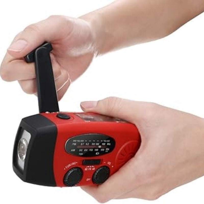Winding the hand crank to charge the radio