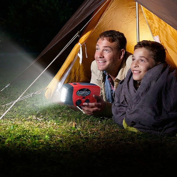 Dad and son in a tent with the radio's torch on